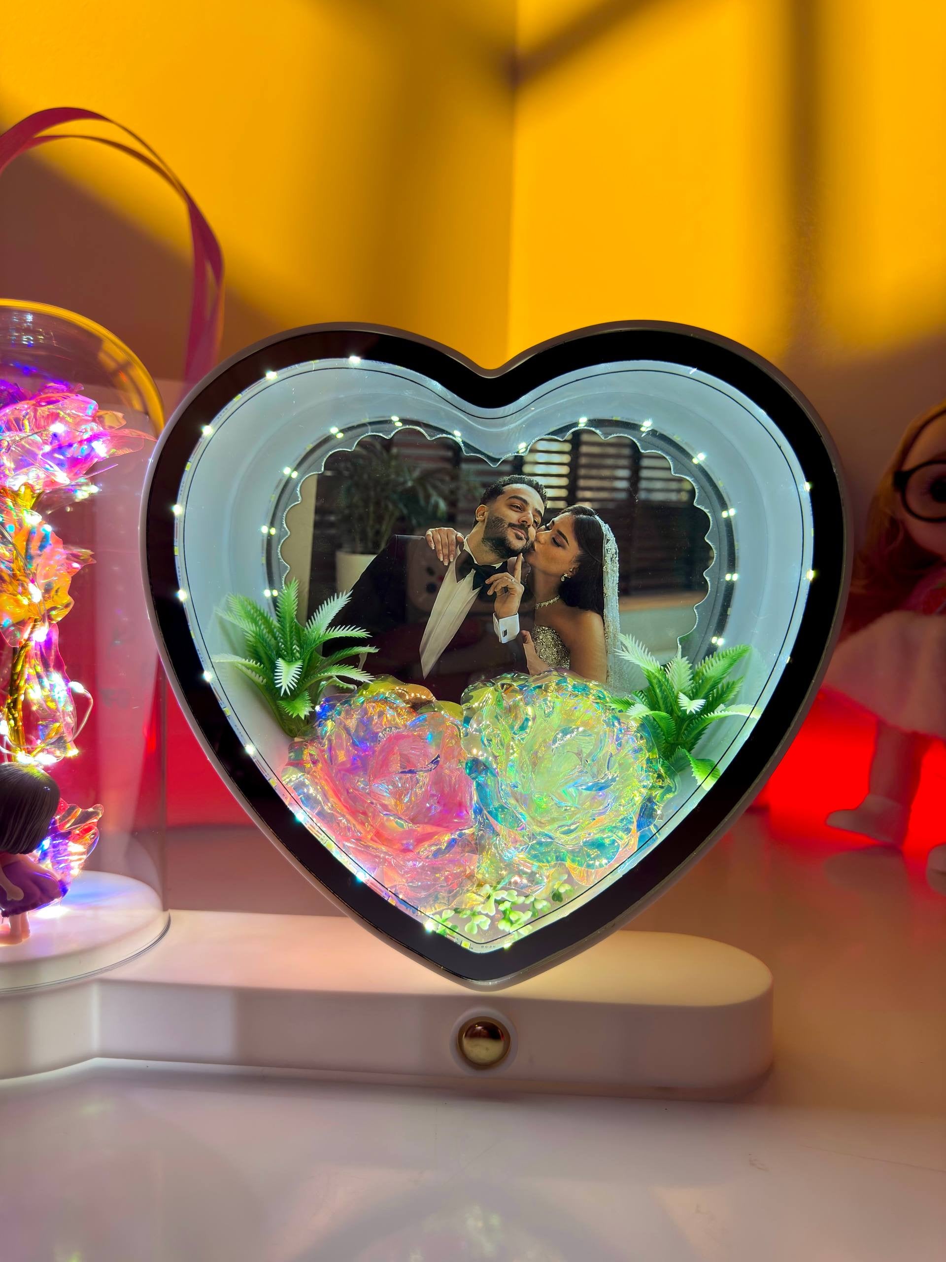 Ayat Gifts heart-shaped magic mirror with personalized couple photo, illuminated rose dome, and kissing couple figurines